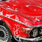 a vintage car getting a wash at a car wash station