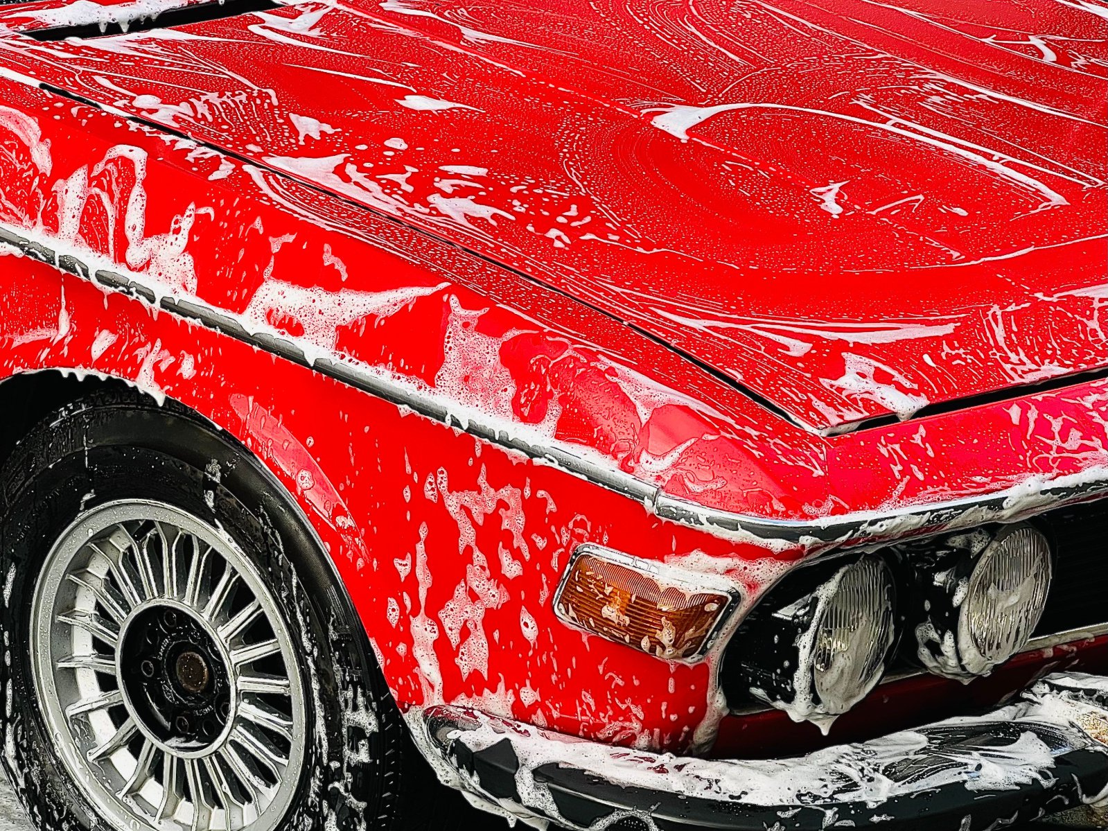 a vintage car getting a wash at a car wash station